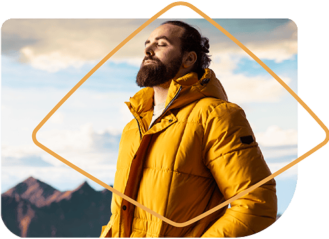 Man standing atop hill breathing easy