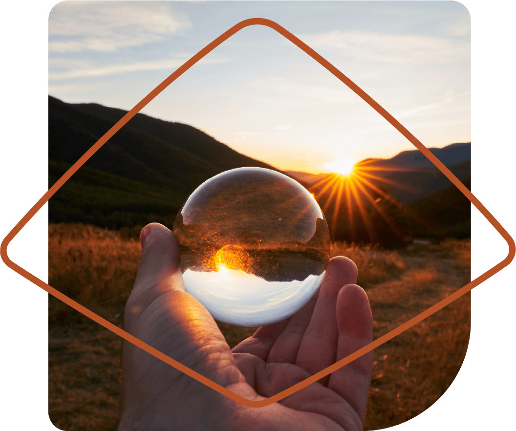 Glass orb capturing sunset in the distance